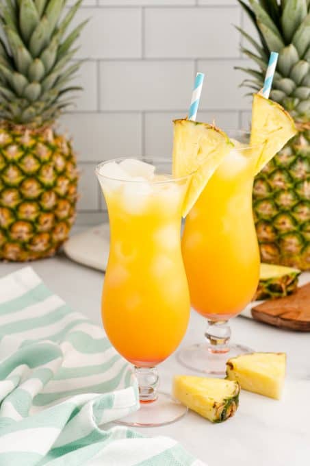 Pineapple wedges decorate the rim of a tropical cocktail.