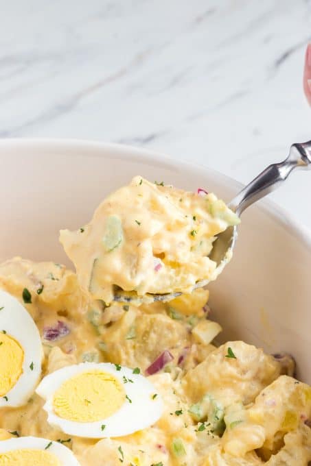 A spoonful of homemade potato salad with Chick-fil-A sauce