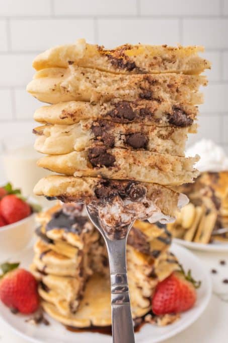 A bite of pancakes with chocolate chips in them.