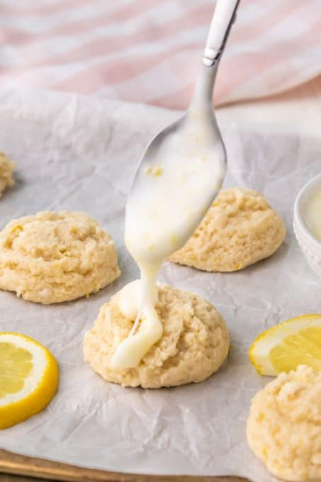 Drizzling lemon glaze to finish the cookies.