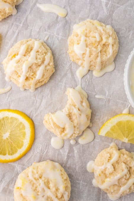 A bite taken out of a cookie with a lemon glaze.