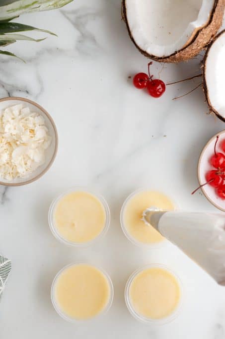 Topping a jello shot with whipped cream