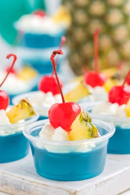 Easy tropical jello shots made with blue gelatin, rum, and pineapple juice.