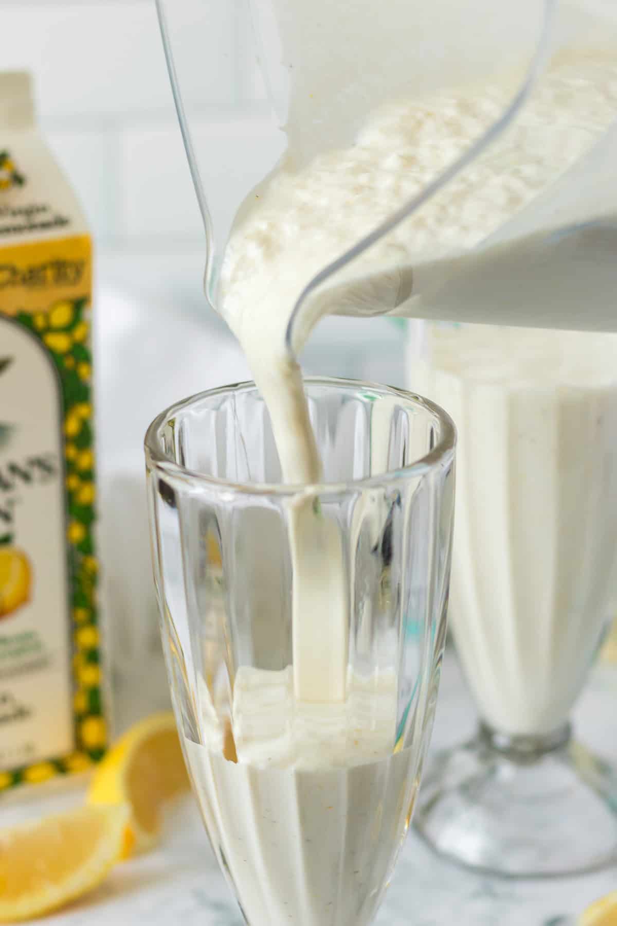 Pouring a Lemon Milkshake into a tall glass.
