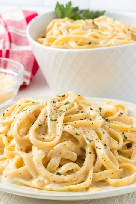 Homemade Alfredo sauce on top of fettuccine noodles.