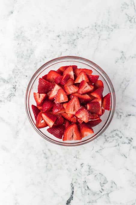A bowl of strawberries sprinkled with vegetable oil and a bit of salt.