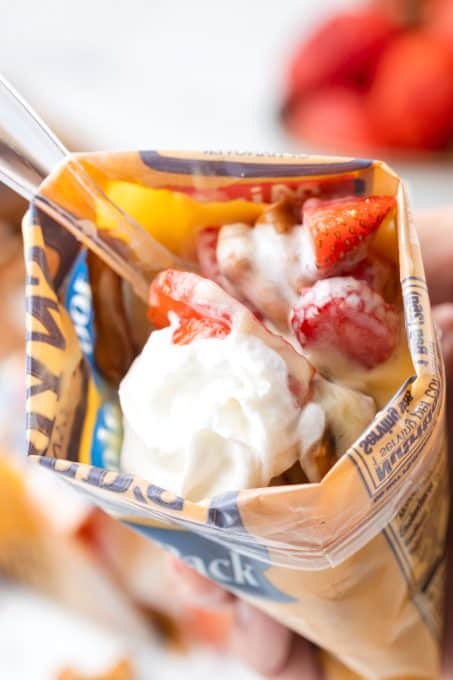 Digging into a strawberry salad with pudding, pretzels and whipped cream.