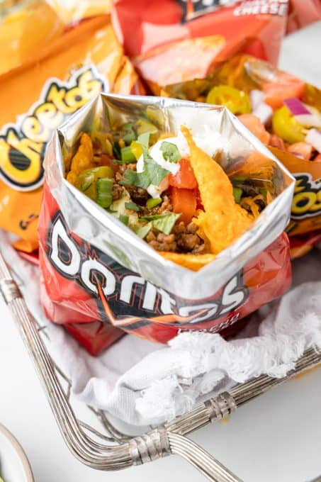 A Doritos bag filled with taco ingredients.