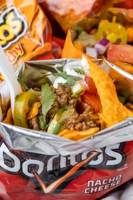 Fill chip bags with the ingredients you want to make a taco.