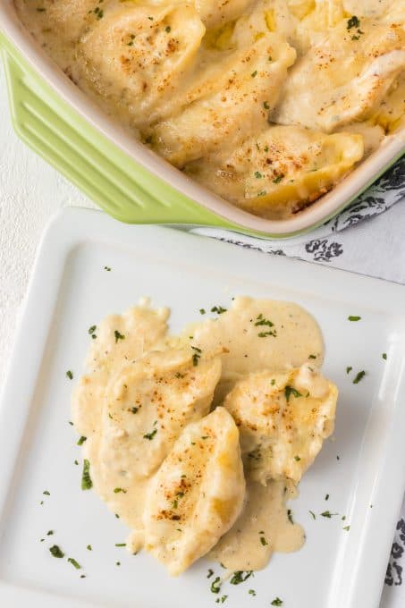 Stuffed chicken pasta shells and white sauce.