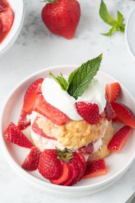 Berries and cream with a sliced shortcake.