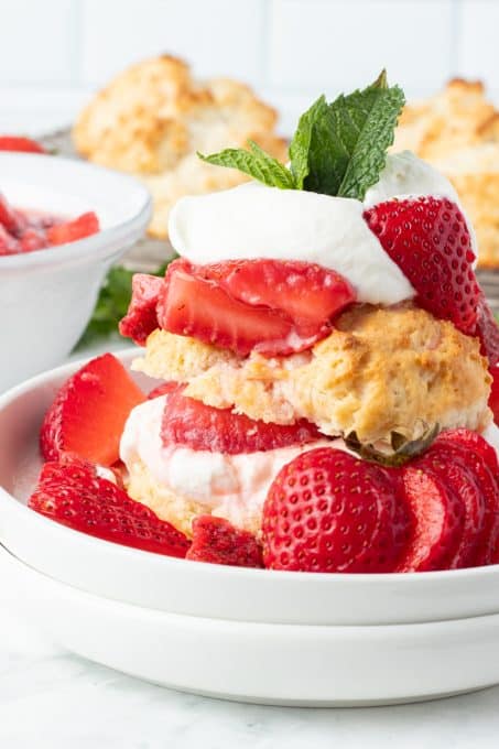 Macerated strawberries, a lightly sweetened biscuit, and whipped cream.