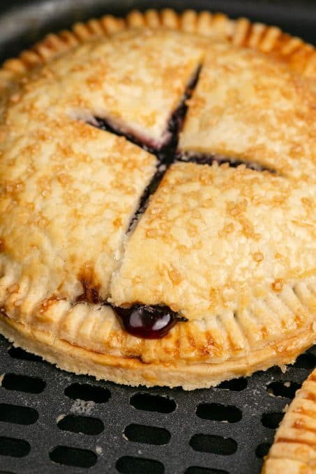 Blueberries oozing out of a hand pie.