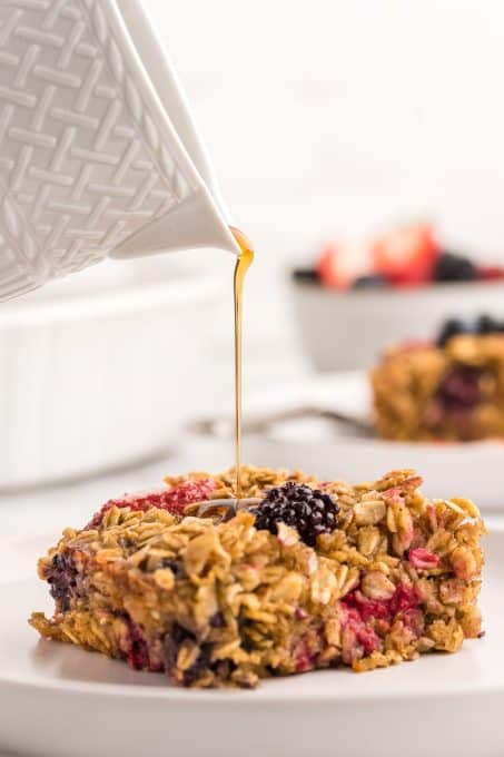 Pouring syrup over baked oatmeal.