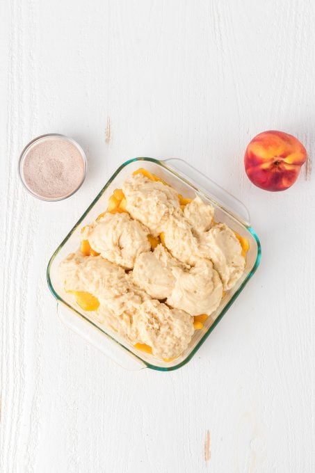 The cobbler dough on top of peaches.