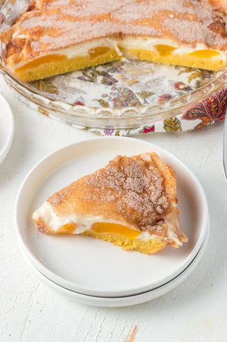 Cinnamon sugar top a peach pie with a vanilla pudding crust.