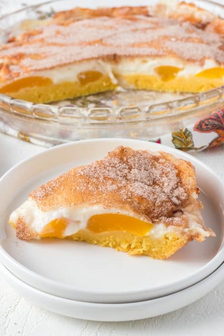 A peach pie with a vanilla pudding crust, canned peaches, and a sweet cream cheese layer.