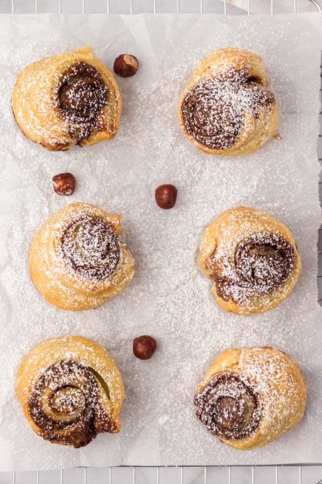 Nutella muffin croissants dusted with powdered sugar.