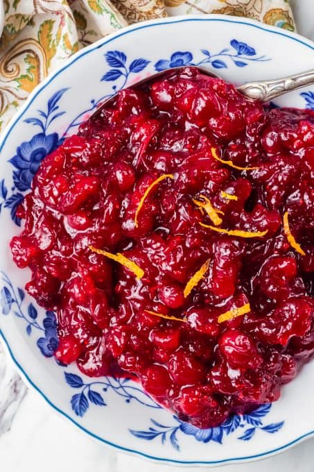 A bowl of fresh cranberries made into a sauce.