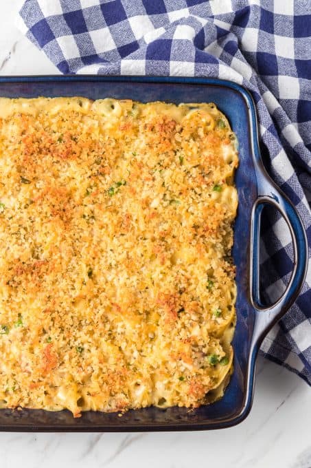 Baked casserole with turkey, noodles, peas and cheese.