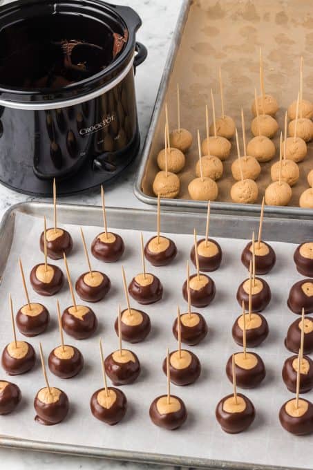 Dipping peanut butter balls in chocolate.