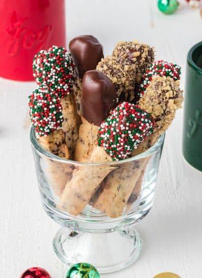 A dish full of decorated stick cookies.