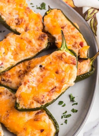 Cheddar and cream cheeses and bacon in jalapeno peppers.