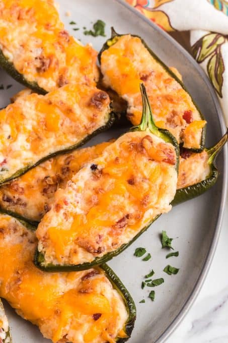 Cheddar and cream cheeses and bacon in jalapeno peppers.