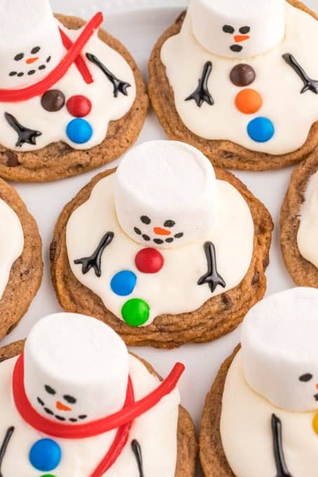 Marshmallows, red licorice, and M&M's help make these little snowmen.