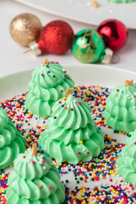 Assorted colored non pareils on meringue cookies.