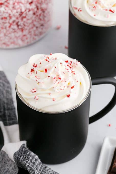 Whipped cream and crushed candy canes on a mocha peppermint latte.