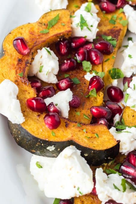 Pomegranate arils and goat cheese on baked acorn squash.