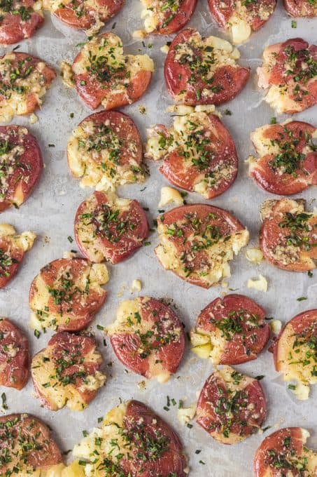 Red potatoes that have been smashed and roasted in the oven.