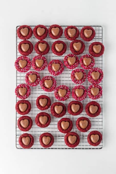 Red chocolate cookies with Valentine sprinkles and a chocolate heart in the center.