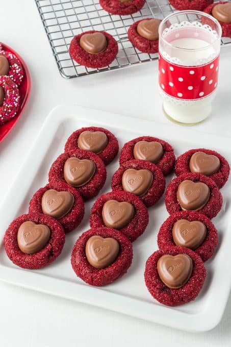 Chocolate cookies covered in red sprinkles with a chocolate heart for Valentine's Day.