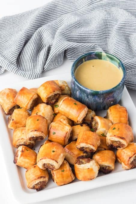 Puff Pasty Sausage Bites with a honey mustard dipping sauce.