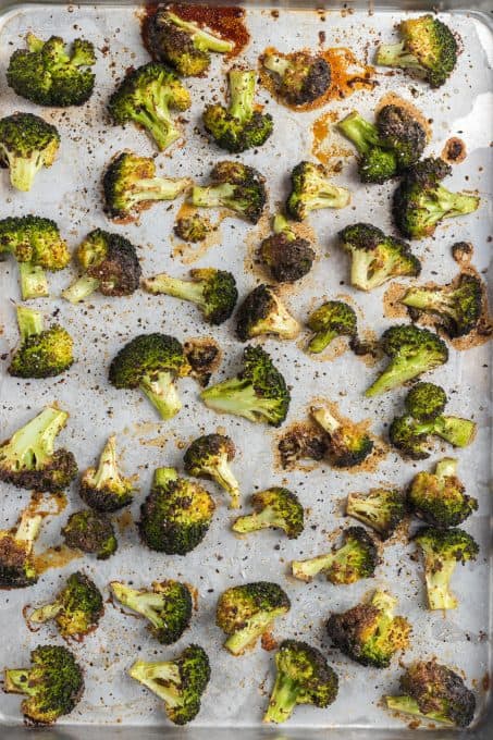 Roasted broccoli on a baking sheet.