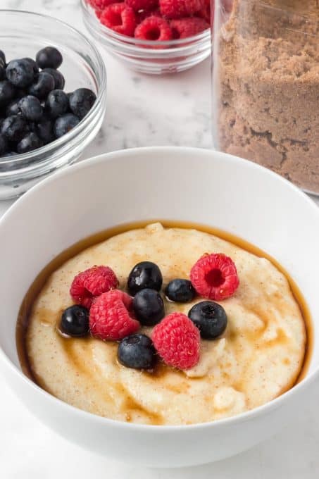 Berries on top of a bowl of warm breakfast cereal.