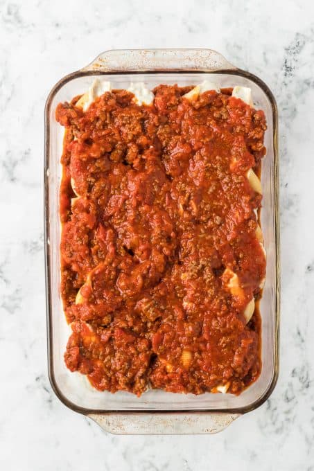 A baking dish full of stuffed pasta shells ready for the oven.