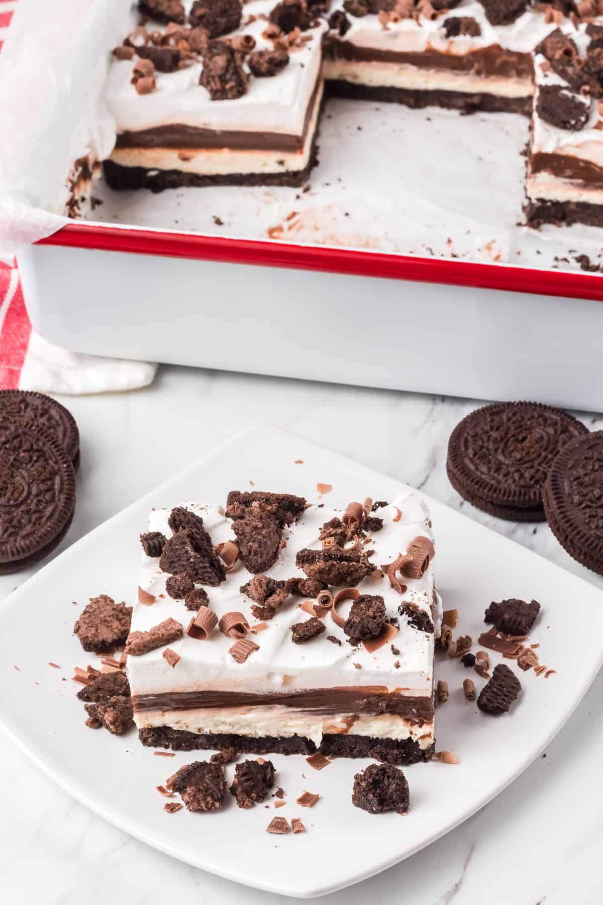 A no bake dessert with an Oreo crust, vanilla cheesecake, chocolate pudding and Cool Whip.