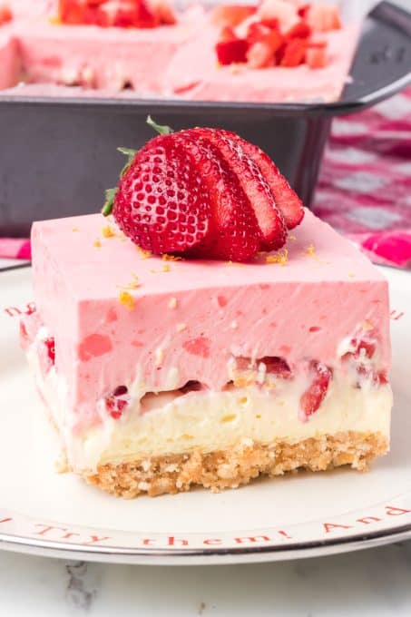 Layers of a Nilla Wafer cookie crust, lemon cheesecake and creamy strawberry gelatin topping.