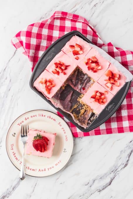 Strawberry cream dream bars with lemon cheesecake in a pan.
