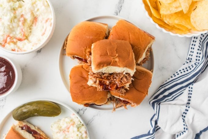 Sliders with BBQ sauce and shredded chicken.
