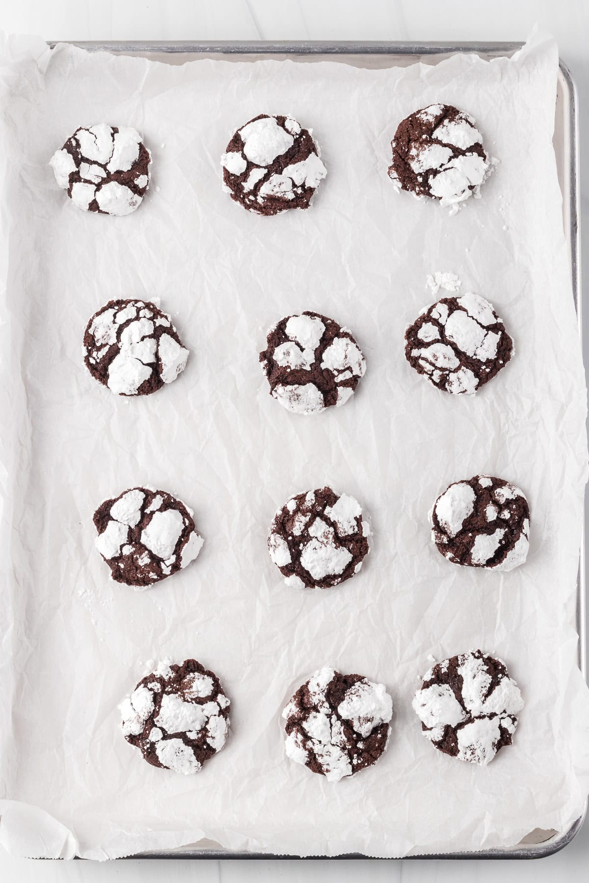 A tray of baked chocolate cookie crinkles.