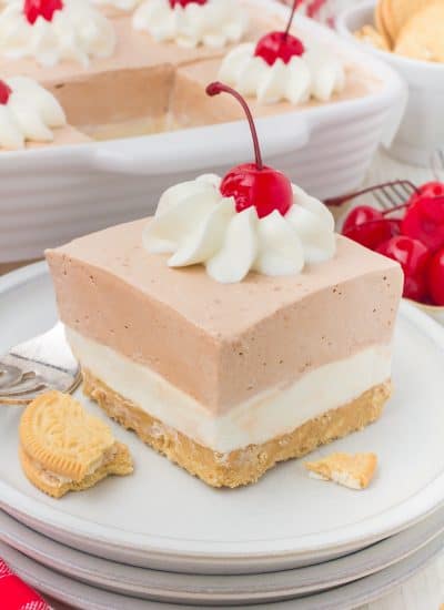 A cheesecake and root beer gelatin dessert on a plate with chopped Golden Oreos.
