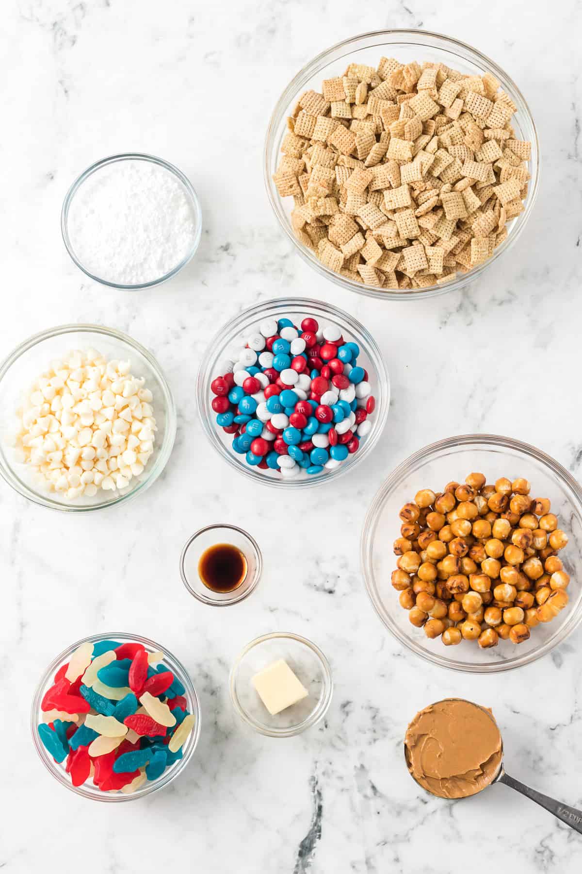 Bowls of ingredients for a Patriotic Chex Mix.