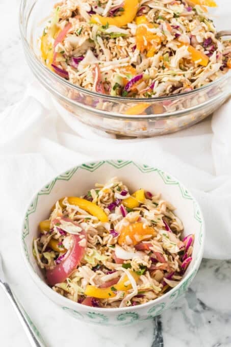 Two bowls full of Ramen Noodle Salad tossed with a ginger dressing.