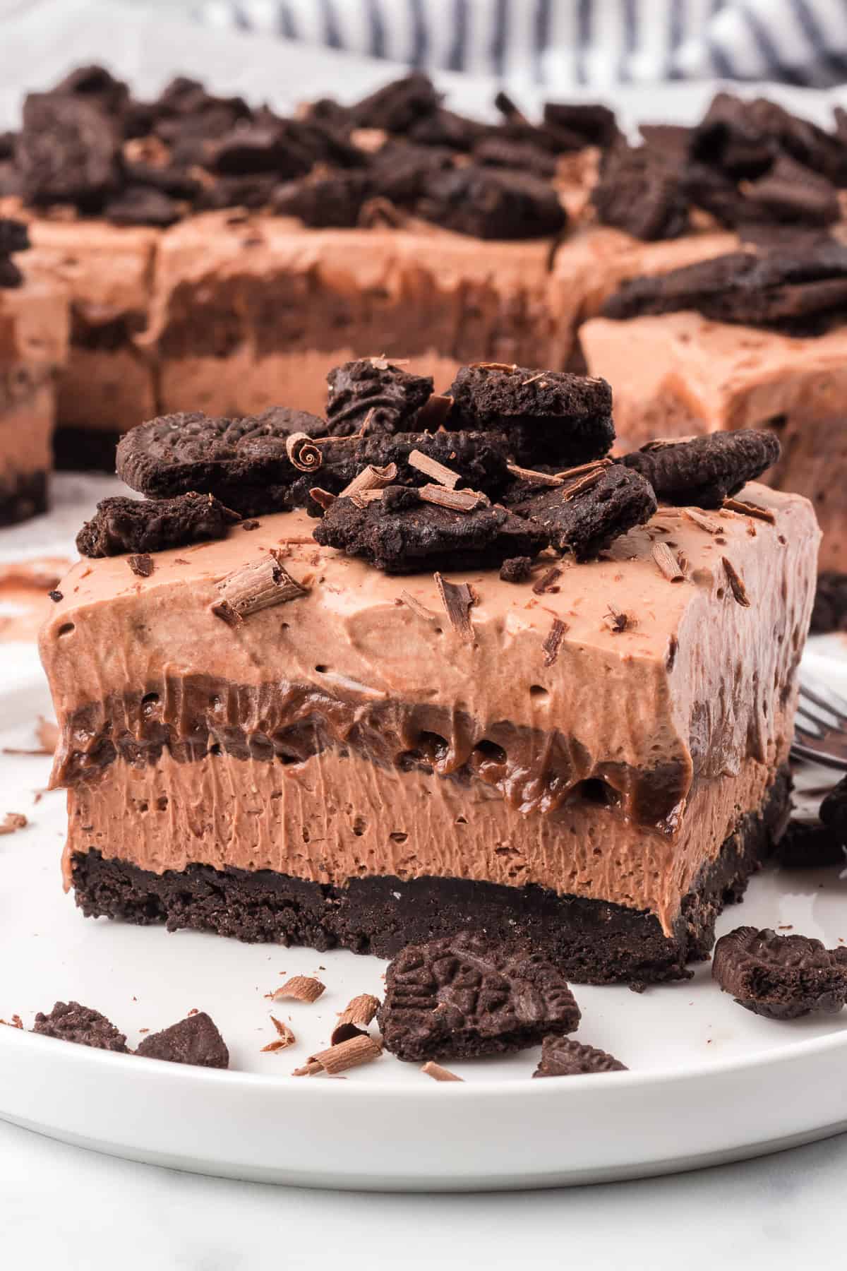 Chocolate layers on top of an Oreo crust on a plate.