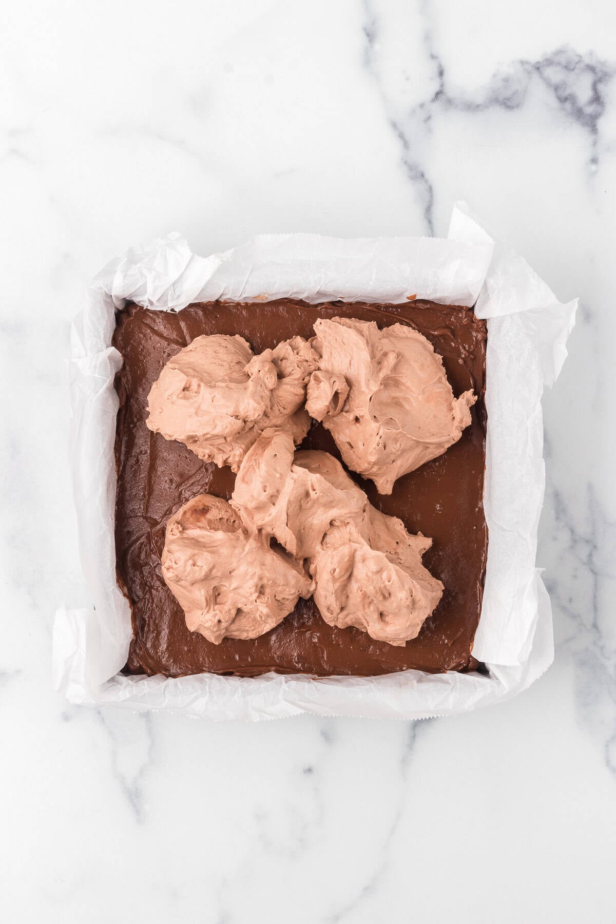 Stabilized Chocolate Whipped Cream on ready to be spread on no bake chocolate bars.