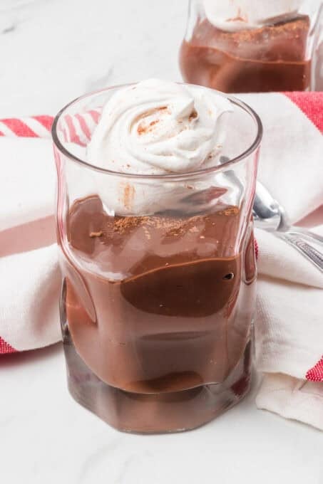 Tofu Chocolate Pudding in a glass with whipped cream.